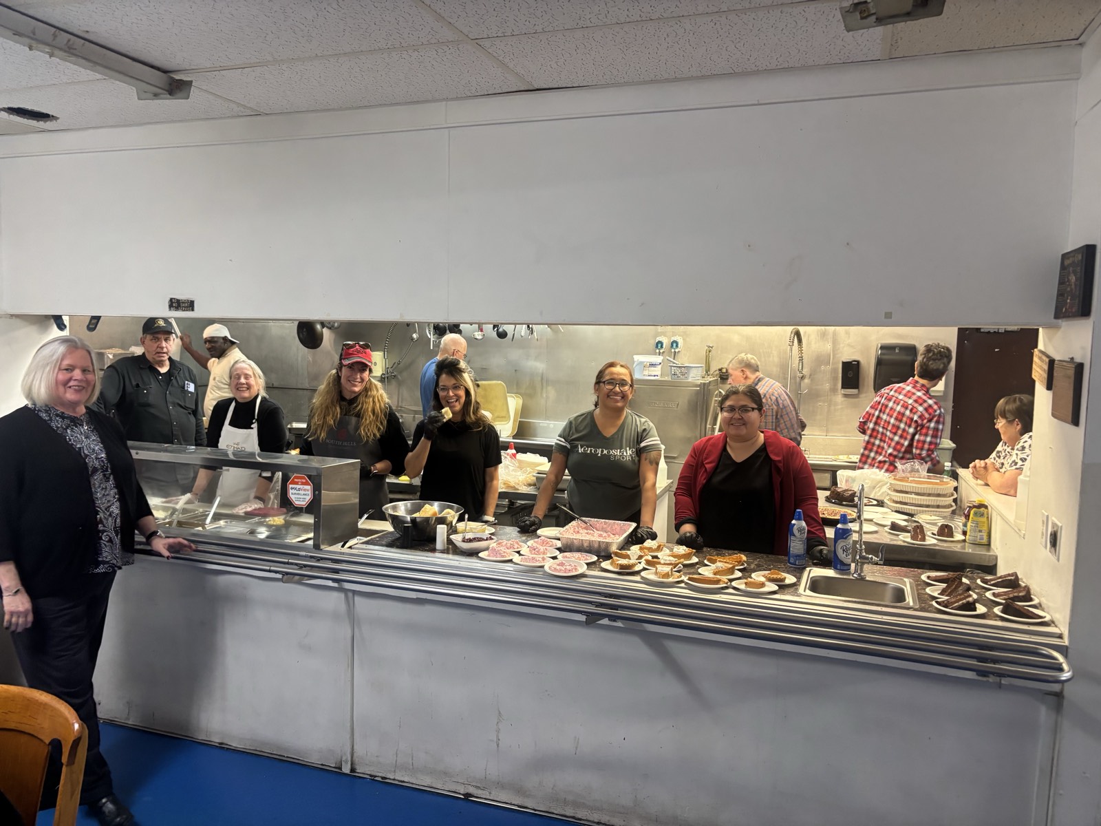 Helena Naz volunteers serving at God's Love shelter